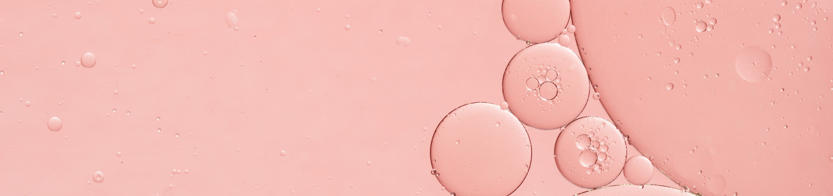 Up close shot of PHA ingredient colored pink in liquid form with small bubbles formed. 